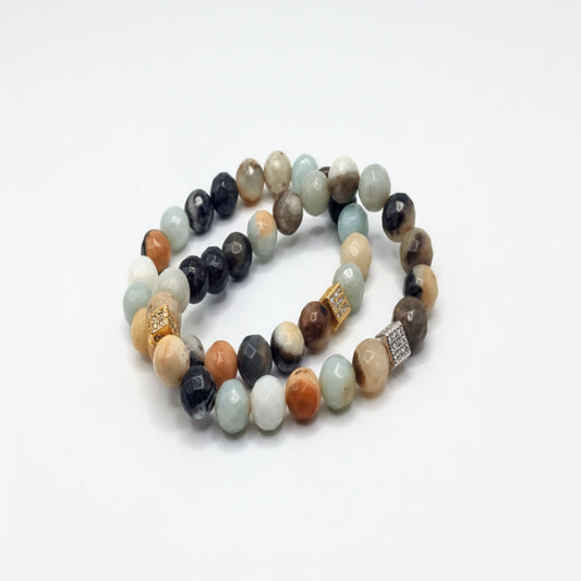 Stack of multicolored beaded bracelets on a white background